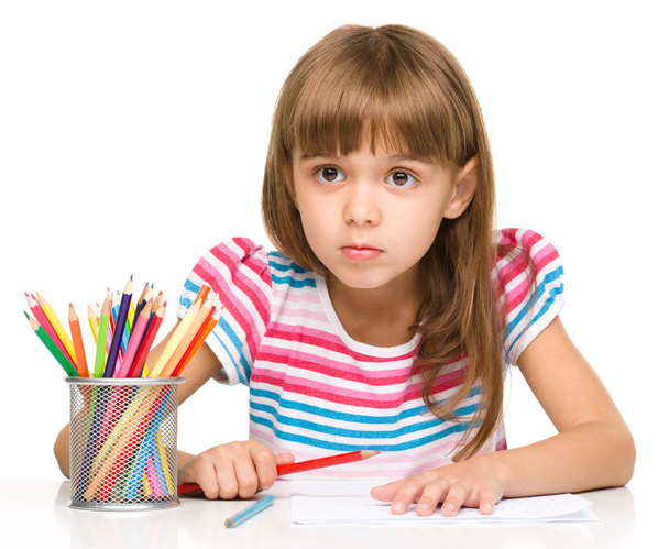 Little girl is drawing using pencils - 写真・画像