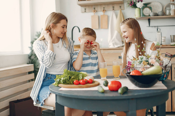 Beautiful big family prepare food in a kitchen - Zdjęcie, obraz