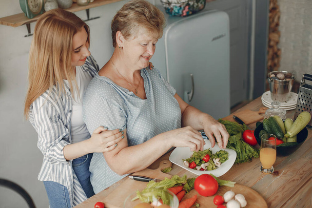 Beautiful family prepare food in a kitchen - Fotografie, Obrázek