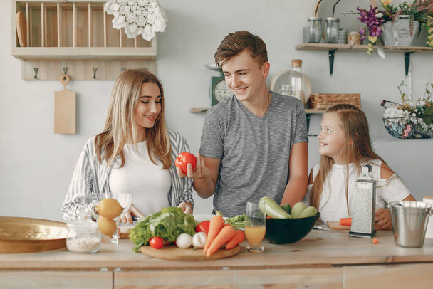 Beautiful family prepare food in a kitchen - Photo, image