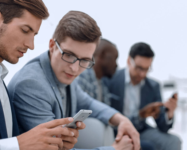 business colleagues reading SMS on smartphone - Φωτογραφία, εικόνα