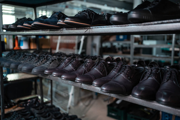 shelf with leather man shoes on modern footwear factory - Photo, image