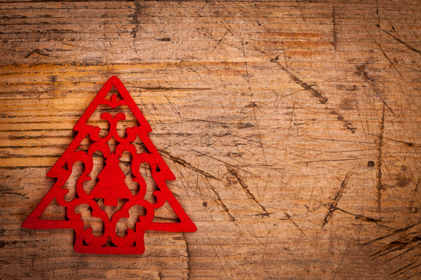 Small red Christmas ornament on wooden background - 写真・画像
