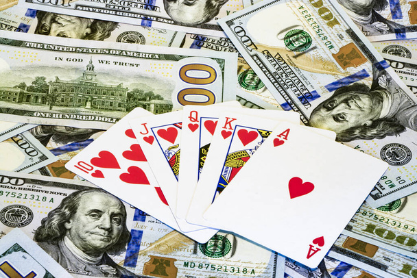 Poker combinations of cards on the background of dollar bills - Valokuva, kuva
