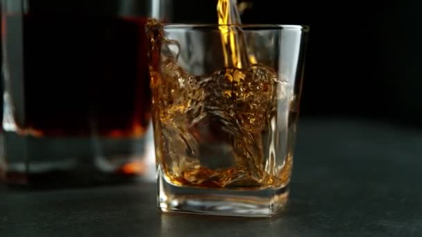 Super slow motion of pouring whiskey or rum with slide motion. Filmed on high speed cinema camera, 1000fps - Felvétel, videó