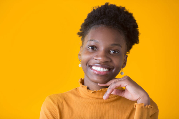 beautiful young african woman on yellow background - Фото, зображення