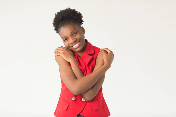 beautiful young african woman on a white background in a red suit - Foto, immagini