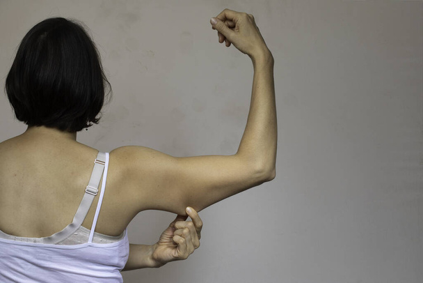 Woman showing flabby arm skin back view - Fotoğraf, Görsel
