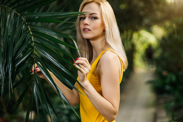 Woman in swimsuit on tropical plants background - Fotografie, Obrázek