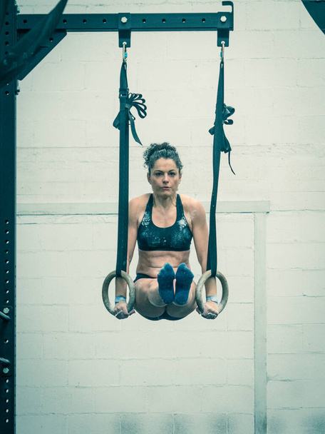 Exercising woman holding gymnast rings - Photo, Image