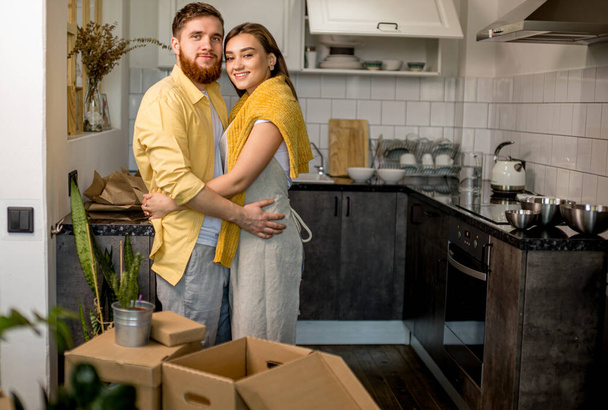 portrait of young happy couple moving in new home - 写真・画像
