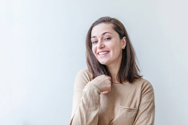 Happy girl smiling. Beauty portrait young happy positive laughing brunette woman on white background isolated. European woman. Positive human emotion facial expression body language - Photo, Image