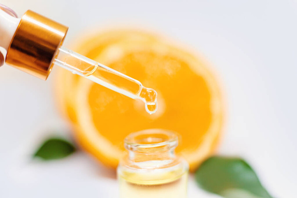 Orange essential oil on a white isolated background. Selective focus. food. - Photo, Image