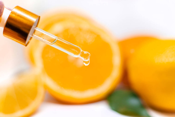 Orange essential oil on a white isolated background. Selective focus. food. - Foto, afbeelding