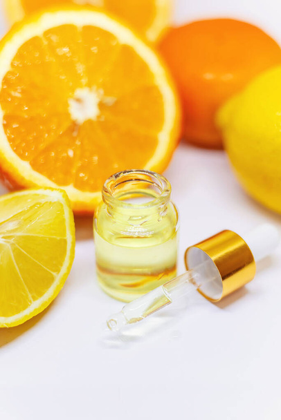 Ätherisches Orangenöl auf weißem Hintergrund. Selektiver Fokus. Lebensmittel. - Foto, Bild