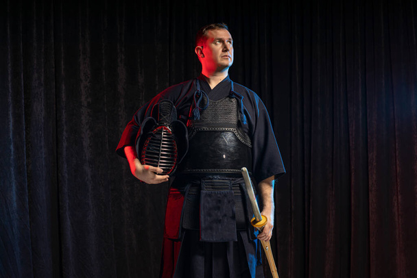 portrait of kendo fighter with bokuto. traditional japanese martial art of sword fighting - Fotó, kép