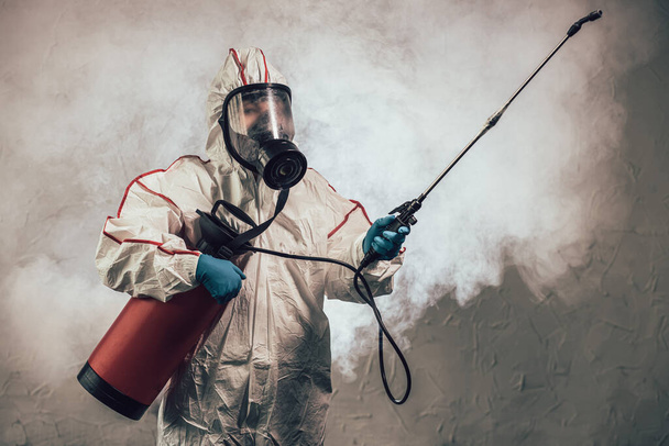disinfector in protective suit conducts disinfection - Foto, Imagem