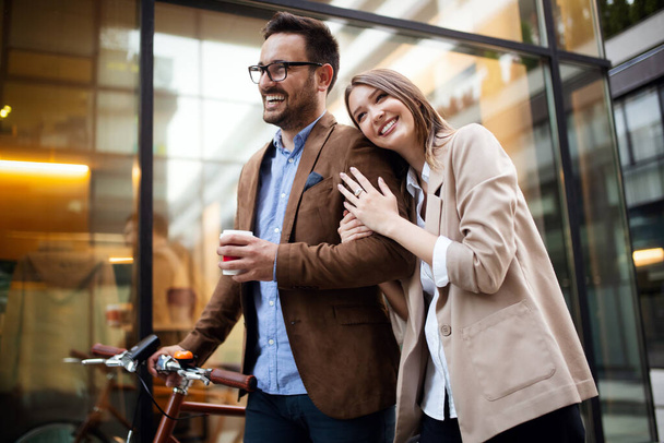 Happy office woman with business man couple enjoying break while talking flirting outdoor - Fotografie, Obrázek