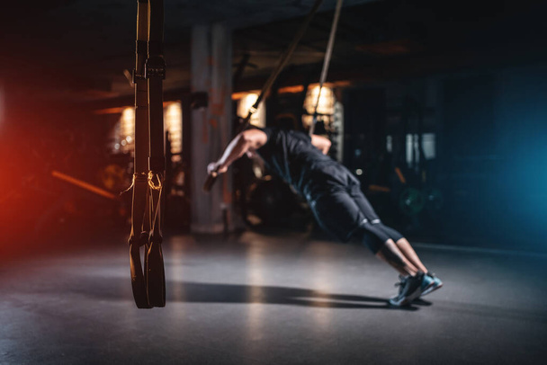 young man has crossfit workout with trx in modern gym - Zdjęcie, obraz