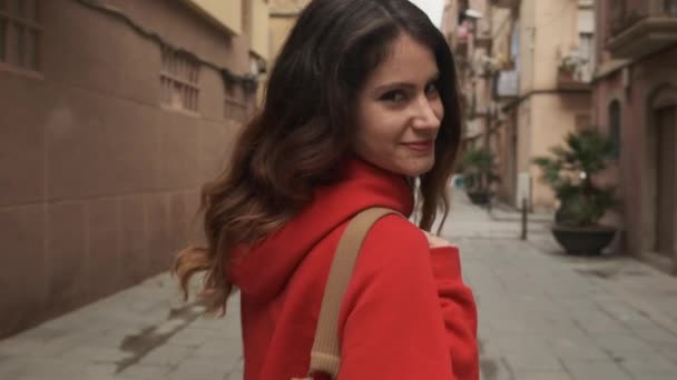 Κοντινό πλάνο του γοητευτικού ισπανόφωνου κοριτσιού με σακίδιο που περπατά ονειρικά κατά μήκος άνετο δρόμο της πόλης - Πλάνα, βίντεο