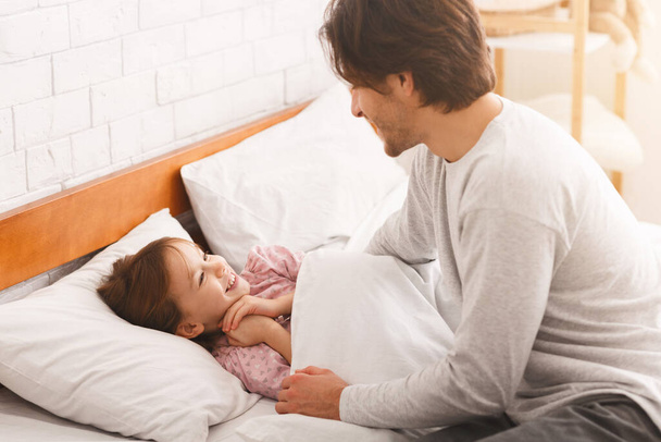 Little girl happy to see her dad in the morning - Photo, Image