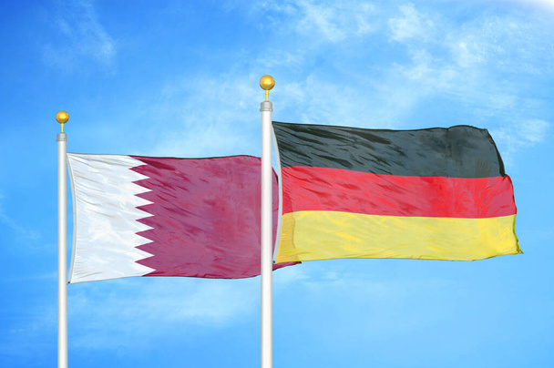 Qatar ja Saksa kaksi lippua lipputangot ja sininen pilvinen taivas tausta
 - Valokuva, kuva