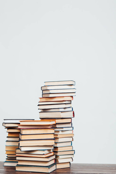 many stacks of educational books to teach at home before exams on a white background - 写真・画像