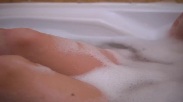 Beauty naked girl relaxing in babble bath, evening self-care routine, cozy home - 映像、動画