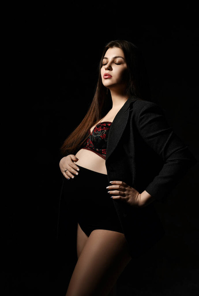 Young beautiful slim pregnant woman with long hair in posing on black background. Pregnancy motherhood, new born life expectation - Fotoğraf, Görsel