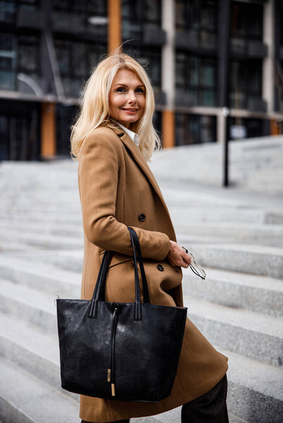 Good-looking blonde woman in a stylish coat - Fotoğraf, Görsel