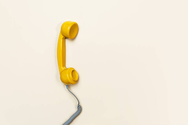 Old fashioned handset on beige background. Modern retro style. - Foto, immagini