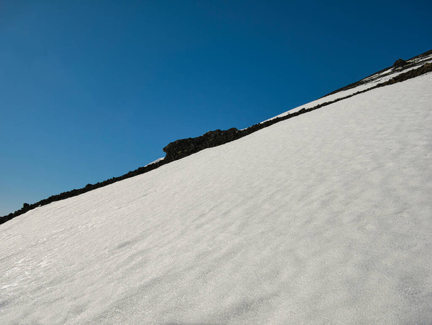 Un pendio di montagna in Islanda con roccia vulcanica e neve splendente
 - Foto, immagini