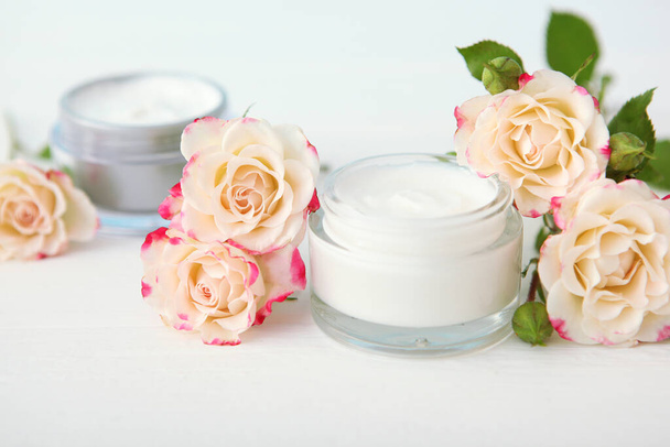 skincare cream and flowers on the table. Cosmetics for skin care. - Foto, Imagen