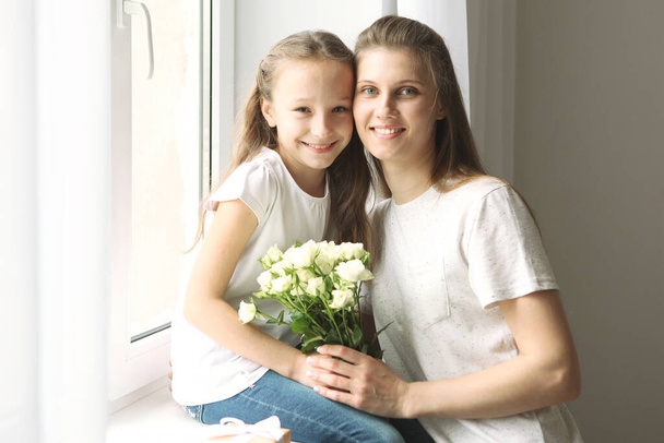 Mother's day concept. Mom and daughter at home - Φωτογραφία, εικόνα