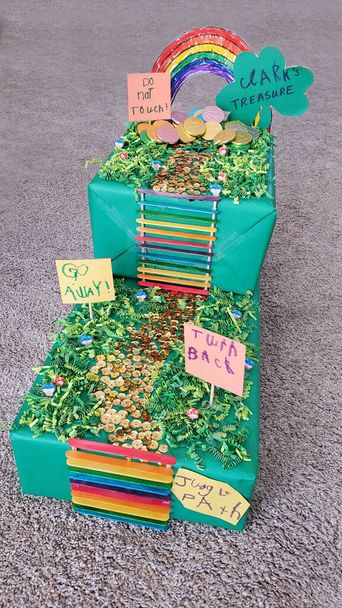 Barevná DIY Leprechaun Trap vyrobený dítětem a matkou pro školní projekt s duhou, žebříkem, stezkou, cedulemi, stezkou a zlatými mincemi. - Fotografie, Obrázek