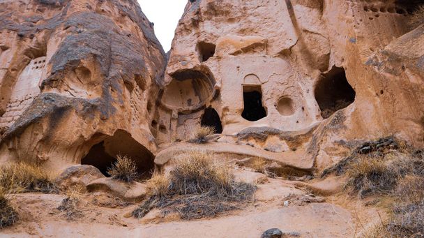 Fairy chimneys and cave houses surrounded by rock formations at Zelve Valley in Cappadocia, Turkey - Zdjęcie, obraz