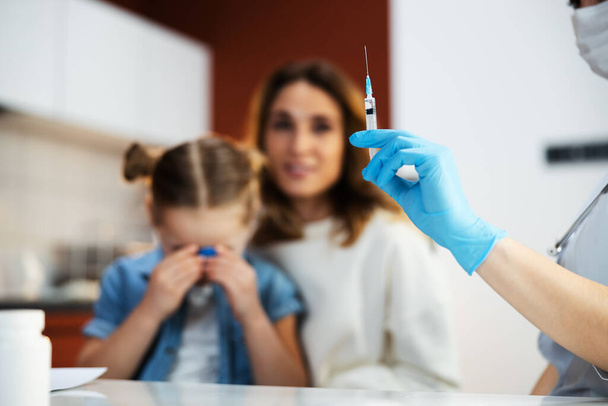 Scared small kid crying in modern clinic - Foto, Bild