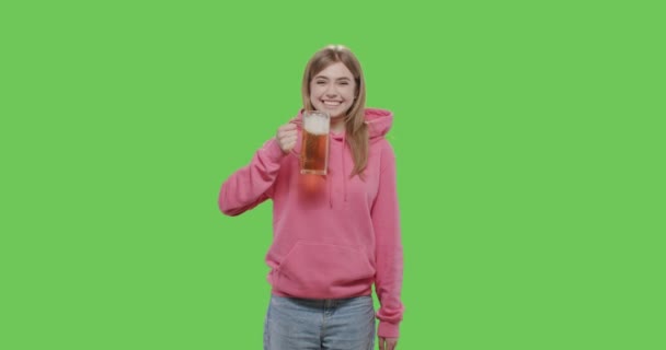 Pretty girl drinking beer from glass - Video