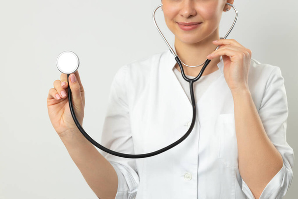Cropped photo of doctor keeping stethoscope in hand indoors - Foto, afbeelding