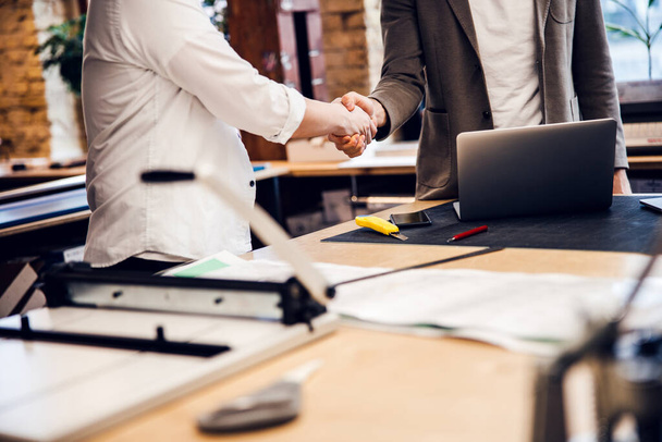 Business partners are shaking hands in office - Fotografie, Obrázek
