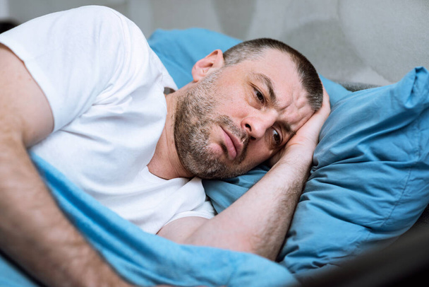Mature Man Lying In Bed Unable To Sleep At Home - Foto, Imagen