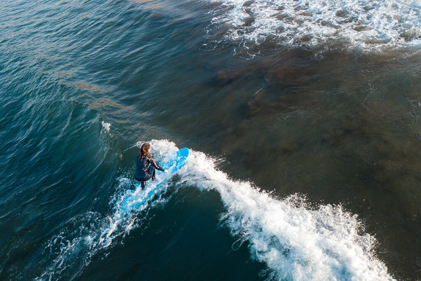 Surfer at the top of the wave, top view aerial shooting surfing - Photo, Image