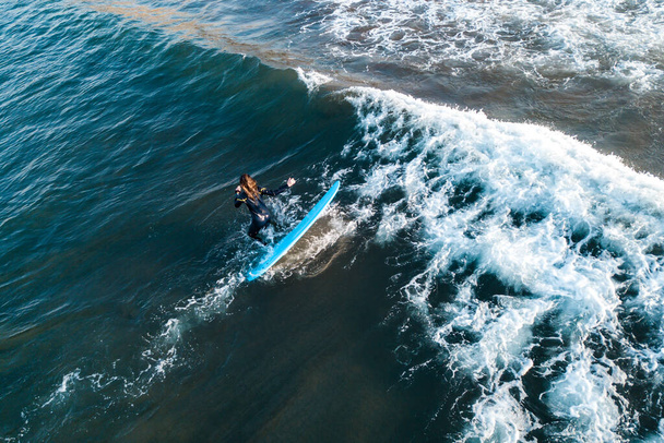 Surfer at the top of the wave, top view aerial shooting surfing - Fotoğraf, Görsel