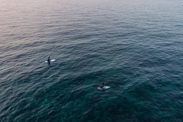 Two surfers in the ocean waiting a wave. shot from above, aerial photography of men on the boards - Foto, Imagen