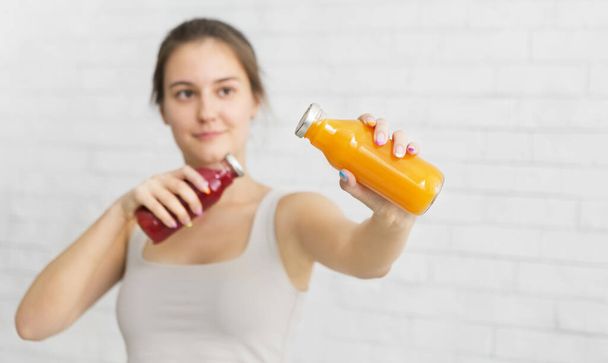 Young woman boxing with detox cocktail in bottles - Foto, immagini