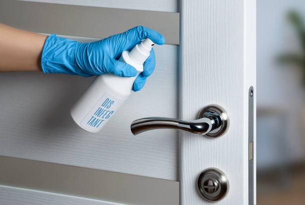 Door handle disinfection for the prevention of viral infection during the COVID-19 pandemic. White door. Door knob. - Photo, Image