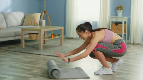 Woman Is Spreading Fitness Mat to Do Morning Exercises - Filmati, video
