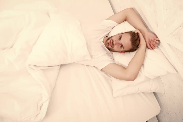 sexy man in bed. early morning wakeup. lazy sunday with morning sex. man lying white bedroom. time to relax. male health concept. man awake in bed. carefree single male seductive attitude - Foto, afbeelding