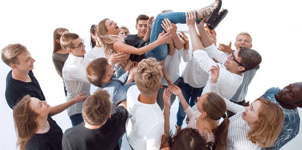diverse young people tossing up their leader. - Фото, изображение