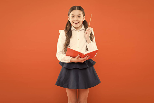 Kid school uniform hold workbook. School lesson. Child doing homework. Your career path begins here. Inspiration for study. Back to school. Knowledge day. Possible everything. Schoolgirl enjoy study - Zdjęcie, obraz